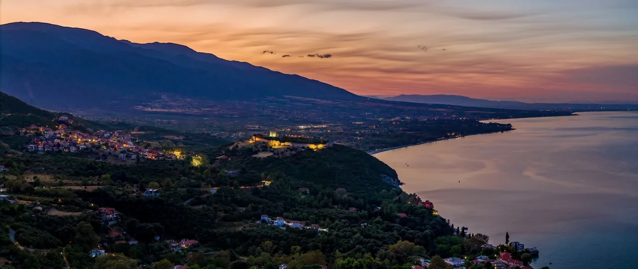 Evening light over the coast of Platamonas: the illuminated castle on its hill below the slopes of Mount Olympus